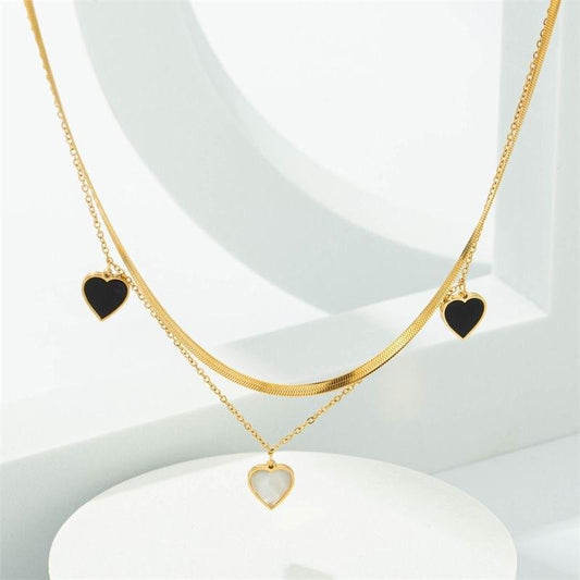 Dual-Layer Golden Necklace with Black and White Heart Pendants