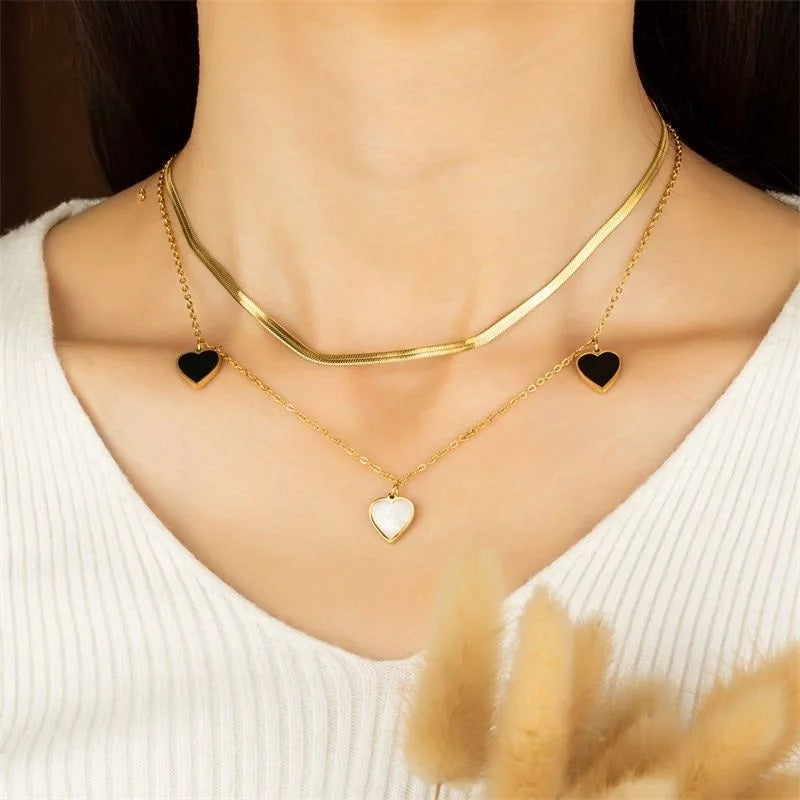 Dual-Layer Golden Necklace with Black and White Heart Pendants