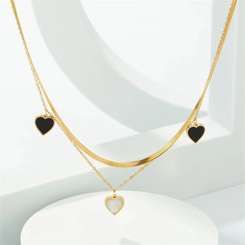 Dual-Layer Golden Necklace with Black and White Heart Pendants