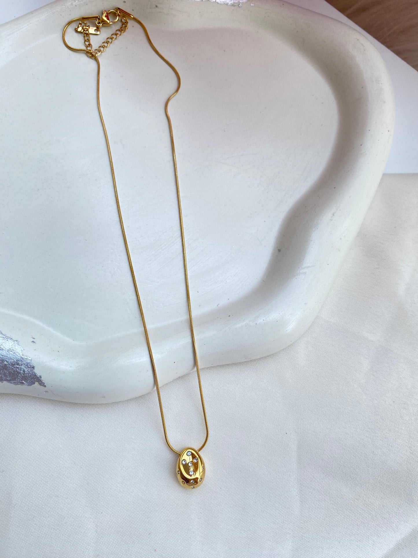 Gold Pleated drop pebble charm necklace