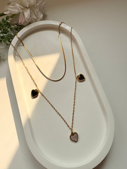 Dual-Layer Golden Necklace with Black and White Heart Pendants